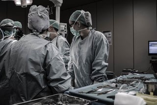surgeons and surgery nurses in the OR with tools by the side