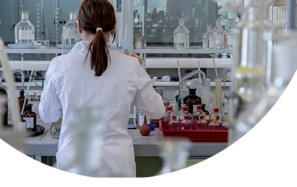 pharmaceutical professional standing in front of lab desk